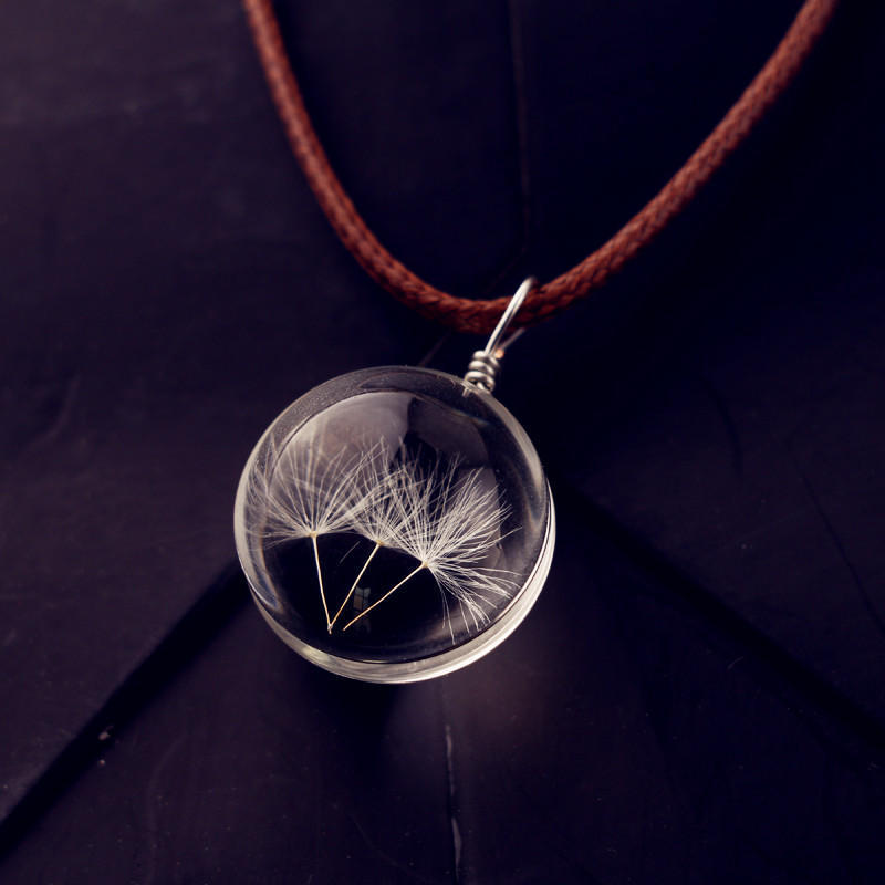 Glass ball necklace containing real dandelion seeds