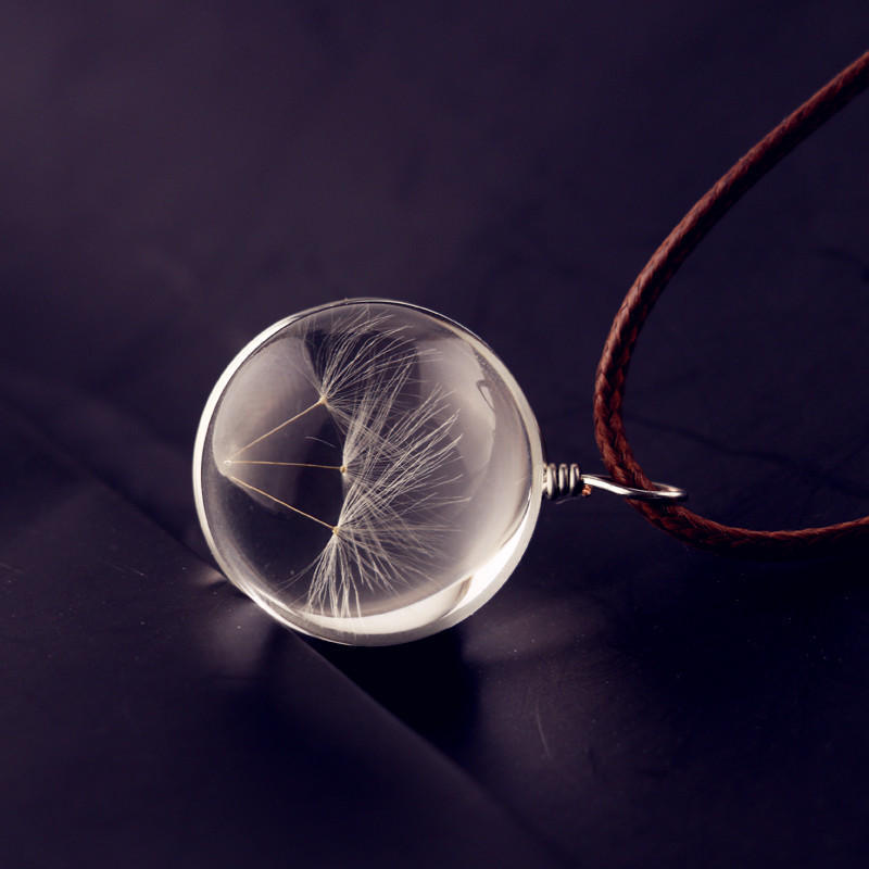 Glass ball necklace containing real dandelion seeds